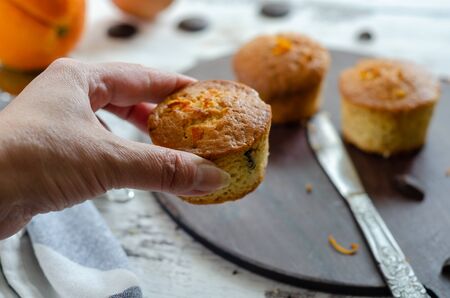 The woman is holding a muffin,top view.