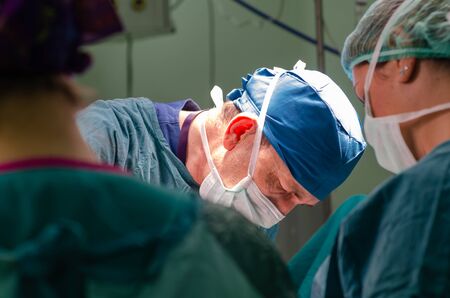 Concentrated doctor and assistant  during a hysterectomy operation in a hospital.Portrait of the surgeon doctor.の写真素材