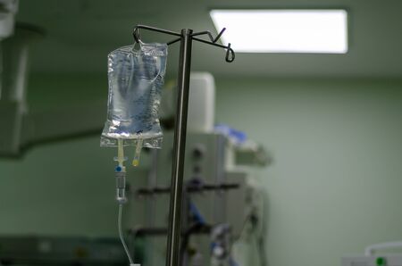Iv solution bag. %5 Dekstrose fluid  is hanging at the surgery room .の写真素材