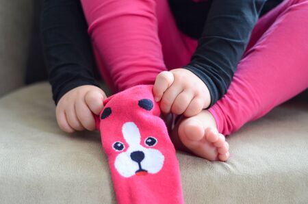 The child is wearing on the sockの写真素材