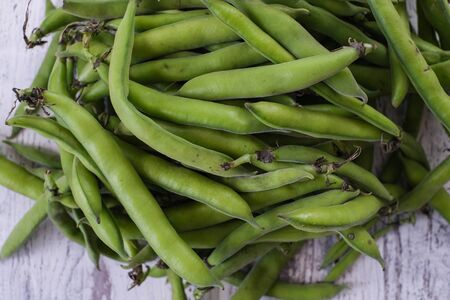Fresh  broad beans in the pod on the white table,close upの写真素材