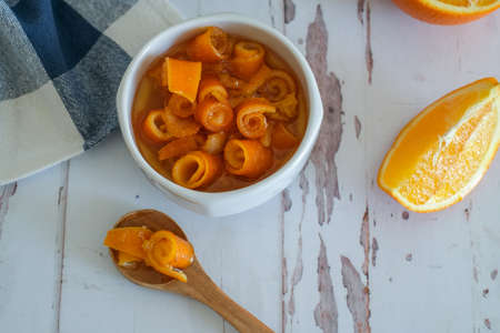 Orange jam served in bowl and spoon on the table