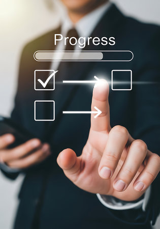 A person in a dark suit and tie is interacting with a digital interface displaying a progress bar and a checklist. One item on the checklist has a checkmark, while another is an empty square. A finger is touching the screen, pointing towards the empty square, indicating a selection or action. The interface elements are white and glowing, with arrows showing direction.の素材