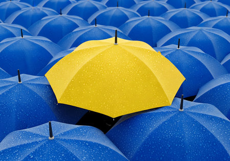 A field of blue umbrellas with water droplets on their surface is contrasted by a single yellow umbrella, also covered in water droplets. The close-up perspective emphasizes the texture and pattern of the umbrellas.の素材