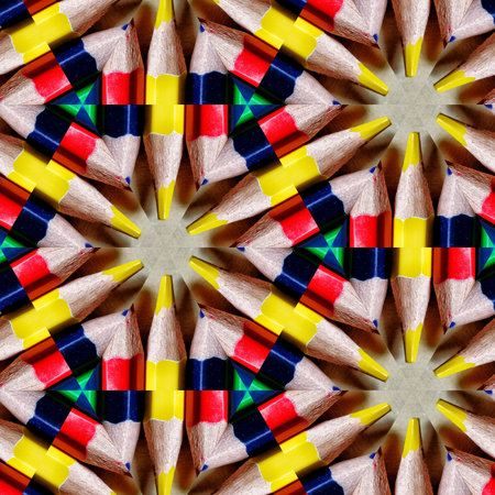 Colorful pencils forming a kaleidoscope pattern on a white backgroundの写真素材