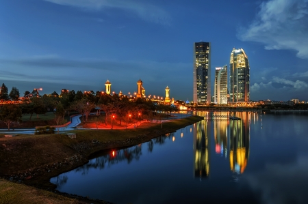 Modern office buildings by Putrajaya Lake, Malaysia at sunset の写真素材