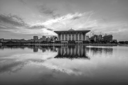 Beautiful mosque with reflection in Putrajaya, Malaysia by the lakeside during sunrise のeditorial素材