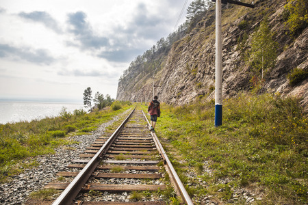 Teenager, stretching into the distance on the railway tracks.の写真素材