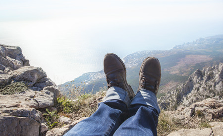 Feet dangling over the precipice.の写真素材