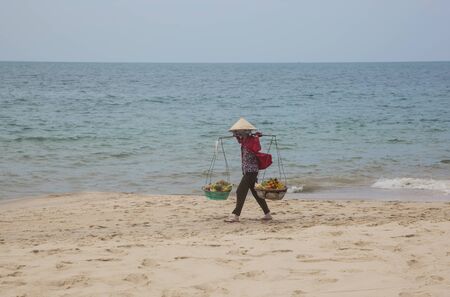 Trader fruit on the beach of Vietnam.の写真素材