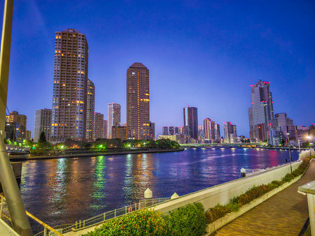 Tokyo, Japan - September 2, 2025 - Residential high-rise buildings and illuminated riverfront in...
