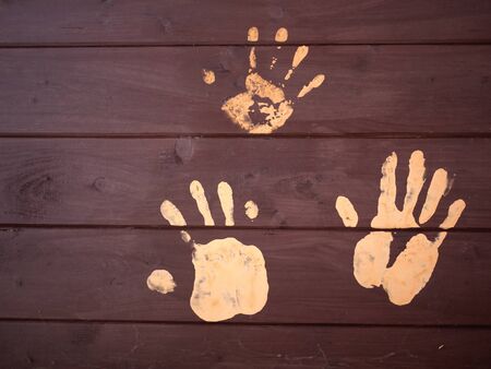 The handprints of mud on a wooden board