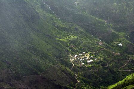 A small village between the hills the sun illuminatedの写真素材