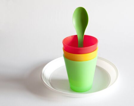 Plastic cups, spoon and plate, still lifeの写真素材