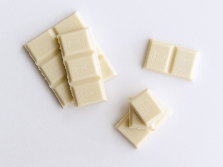 Some pieces of white chocolate on a white background