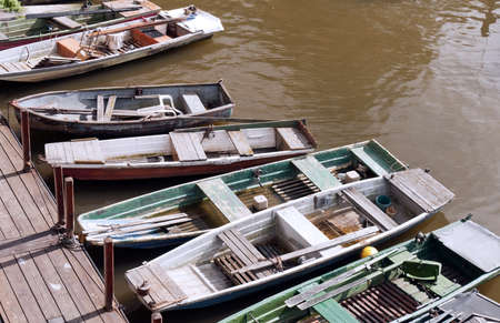 Old fishing boats moored on the river bankの写真素材