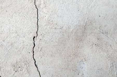 A grey concrete wall with crack 