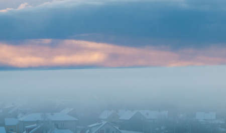 The landscape with fog in a town in winter