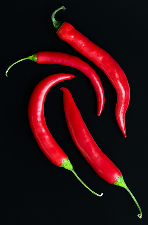 Chili peppers (also chile pepper or chilli pepper) on the black backgroundの写真素材