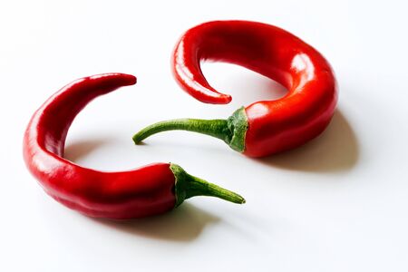 Two chili peppers on the white backgroundの写真素材