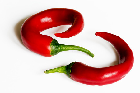 Two chili peppers on the white backgroundの写真素材
