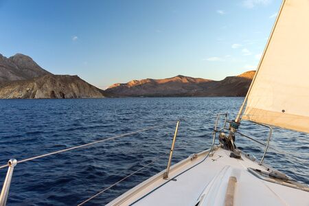 View from a sailboat on the shore in the eveningの写真素材