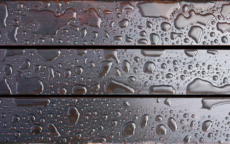 Drops of water on a wooden bench. After rain.の写真素材