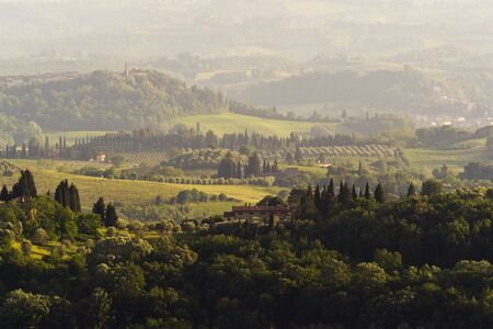 The hilly landscape and the evening sunlight. Tuscany, Italyの写真素材