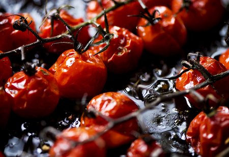 Small red oven-baked tomatoes. Shallow depth of field.の写真素材