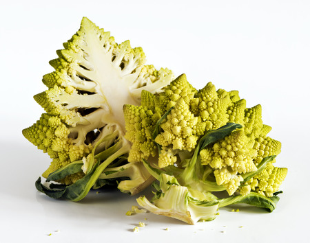 A halved Romanesco broccoli (also known as Roman cauliflower) on a white backgroundの写真素材