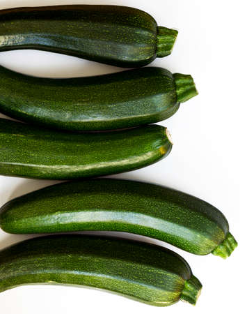 A group of green zucchini (zucchetti, courgettes) on a white backgroundの写真素材