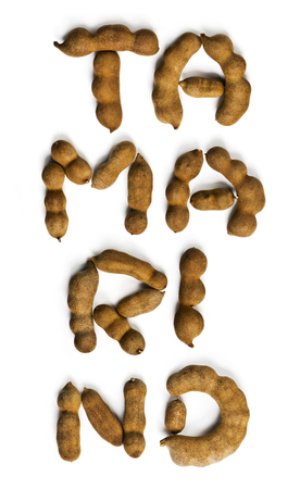 Word tamarind made of tamarind fruits on the white background. Top viewの写真素材