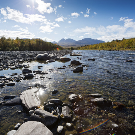 Landscape with a river and mountains. Abiskojokk (river) in the Abisko National Park, Swedenの写真素材