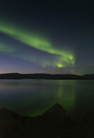 Landscape with Aurora borealis and Tornetrask lake. Northern Swedenの写真素材