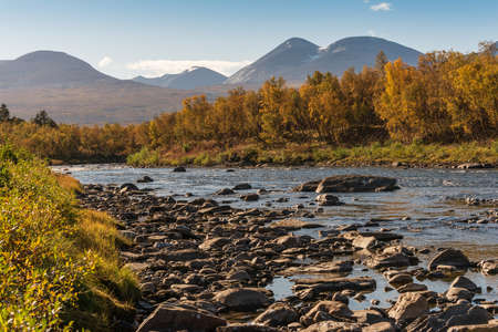 Autumn landscape with Abisko river and mountains. Northern Swedenの写真素材