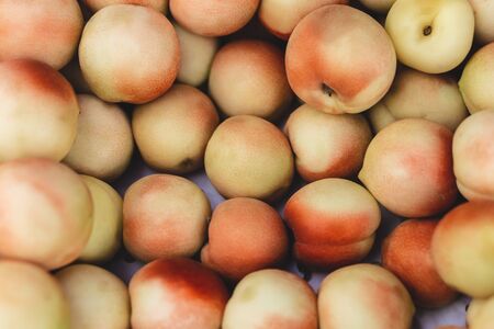 A lot of peaches in box on sale at farms market. peaches background. selective focusの写真素材