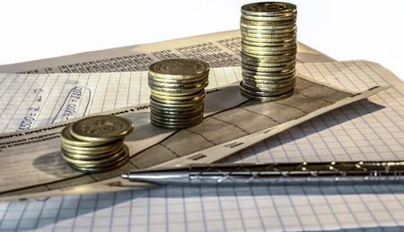 Uptrend stacks coins,on the financial stock charts as background 