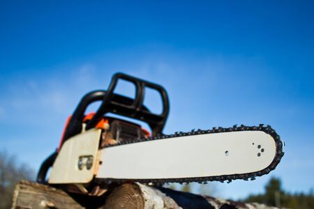 Orange chainsaw with emphasis in bladeの写真素材