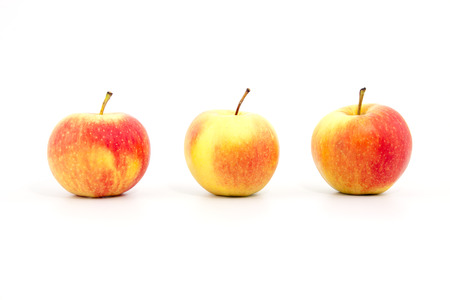 three red apples on a white backgroundの写真素材