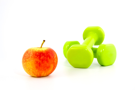 two dumbbells and the apple on a white backgroundの写真素材