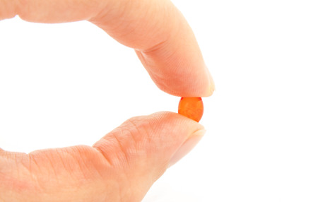 red pill on white backgroundの写真素材