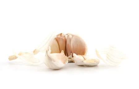 cloves of garlic on a white backgroundの写真素材