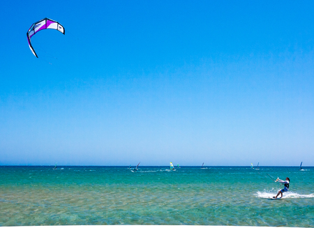 Surfers ride the waves in the seaの写真素材