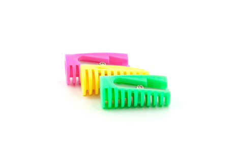 three colored pencil sharpeners, yello, pink, greenの写真素材