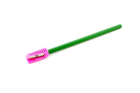 green pencil with sharpener on a white backgroundの写真素材