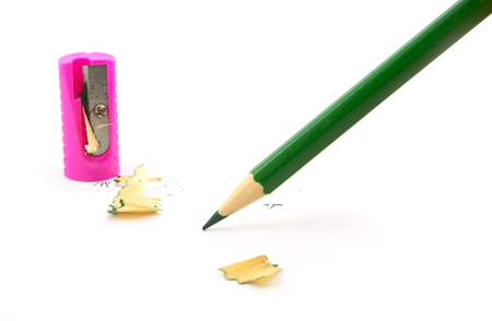 green pencil with sharpener on a white backgroundの写真素材