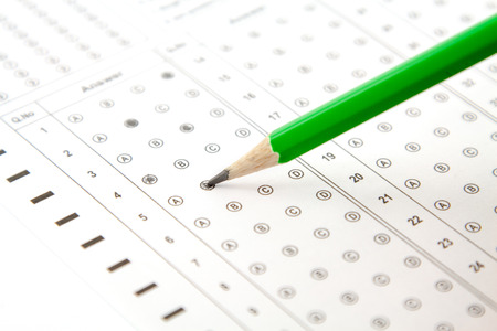 green pencil and the answers to the testの写真素材