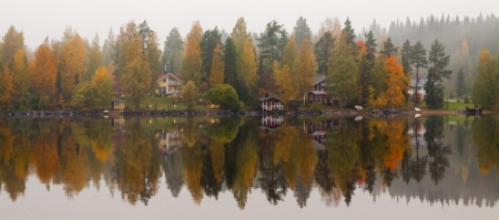 Autumn lake with trees mirroringの写真素材