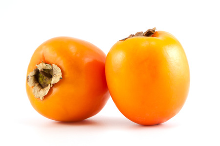 Two orange fresh organic persimmon on white backgroundの写真素材