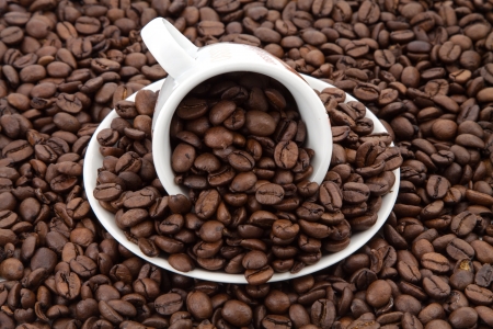 coffee cup with beans, coffee beans backgroundの写真素材